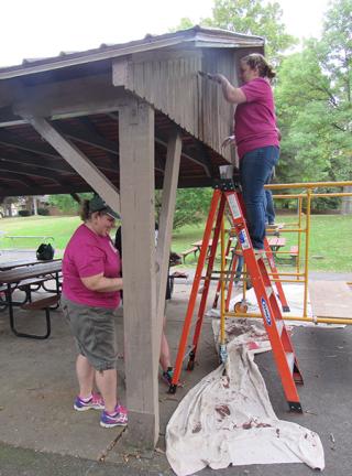 volunteers painting a pavilion